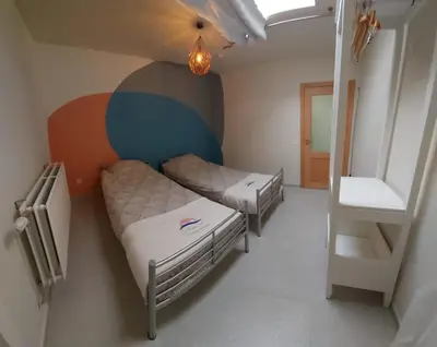 a small room with two bunk beds and a staircase at Le Pepin Dort in Pepinster