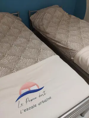 a bed with a sign on the side of it at Le Pepin Dort in Pepinster
