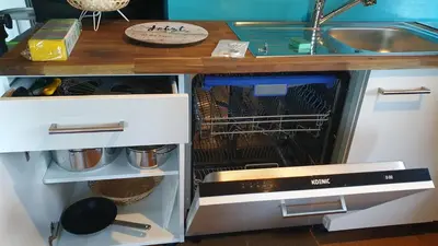a dishwasher in a kitchen next to a sink at Studio Klimt Eupen in Eupen