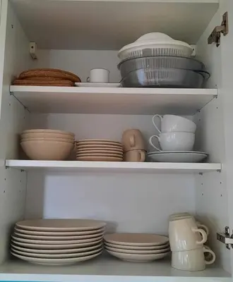 a closet filled with plates and bowls and dishes at Studio Klimt Eupen in Eupen