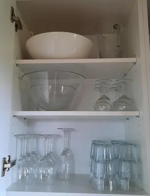 a cabinet filled with wine glasses and a bowl at Studio Klimt Eupen in Eupen