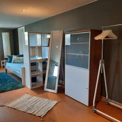 a living room with a refrigerator and a mirror at Studio Klimt Eupen in Eupen