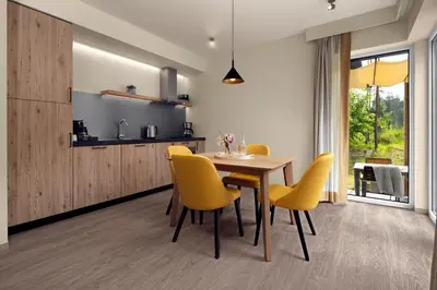 a dining room with a table and yellow chairs at Terhills Resort by Center Parcs in Dilsen-Stokkem