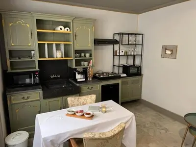 a kitchen with a table with a white table cloth at B&B Els in Locht