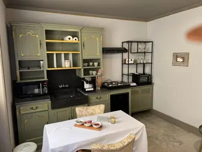 a kitchen with a table with a white table cloth at B&B Els in Locht