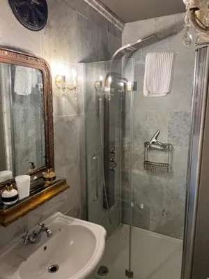 a bathroom with a shower and a sink and a toilet at B&B Els in Locht