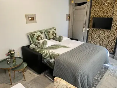 a bedroom with a bed and a small table at B&B Els in Locht