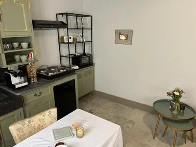 a kitchen with a table and a counter with a table and a tableablish at B&B Els in Locht