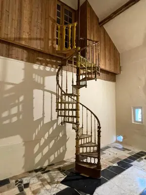 a spiral staircase in a house with its shadow at Ca'Triz in Borgloon