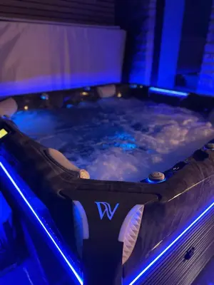 a jacuzzi tub in a room with blue lights at Hof Gemehret in Eupen