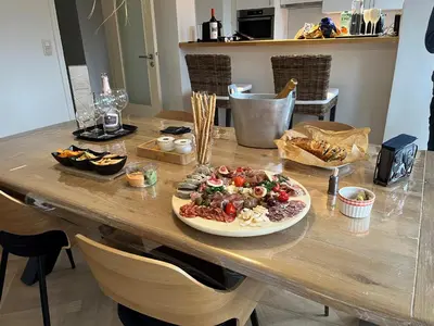 a table with a plate of food on it at Cosy Louvrex -Liège Francorchamps in Liège