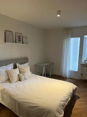 a bedroom with a large white bed with pillows at Cosy Louvrex -Liège Francorchamps in Liège