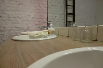 a bathroom sink with a towel on a counter at Domein Tombos in Gingelom
