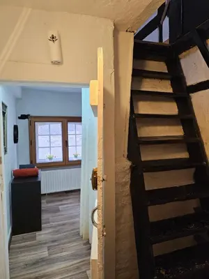 a room with a spiral staircase in a house at Logment saint denis in Liège