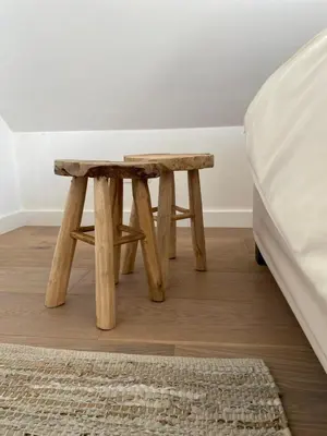 a wooden table next to a bed in a room at Vakantiehuis Zand7 in Lommel
