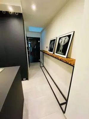 a hallway with two framed pictures on a wall at Superbe appartement chic et design in Seraing