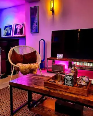 a living room with a couch and a table and a tv at Superbe appartement chic et design in Seraing