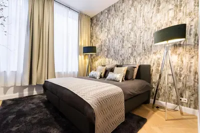a bedroom with a bed and a wall mural at The 99, Appartement sauna & parking in Liège