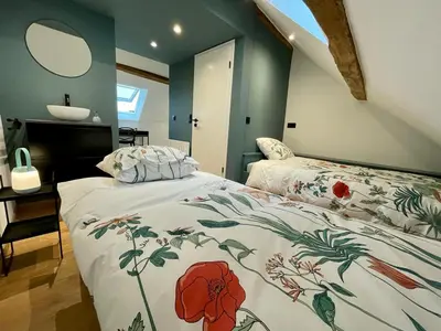a bedroom with a bed and a sink in it at Gite de Clermont in Thimister