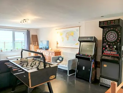 a living room with a game console and a video game at Belevingshoeve 