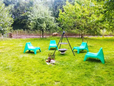 a group of chairs and a swing in a yard at Belevingshoeve 