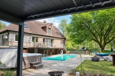 a backyard with a swimming pool and a house at Arthurs Palace in Heusden - Zolder