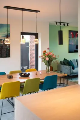 a dining room with a table and chairs at unique hideaway, holiday house with large garden in Kortenaken