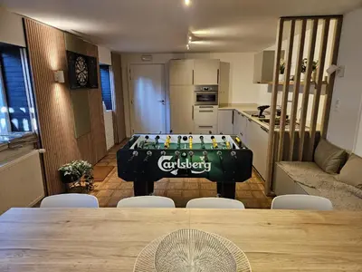 a room with a pool table in the middle of a kitchen at Parkvilla Vakantiehuis voor 23 personen in Heusden - Zolder