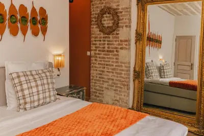 a bedroom with a bed and a mirror at Time - Out Genoelselderen in Riemst