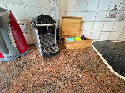 a kitchen counter with a hair dryer next to a mixer at Agréable duplex proche de toutes commodités in Ans