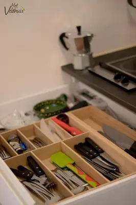 a drawer in a kitchen filled with utensils at Het Veldhuis in As